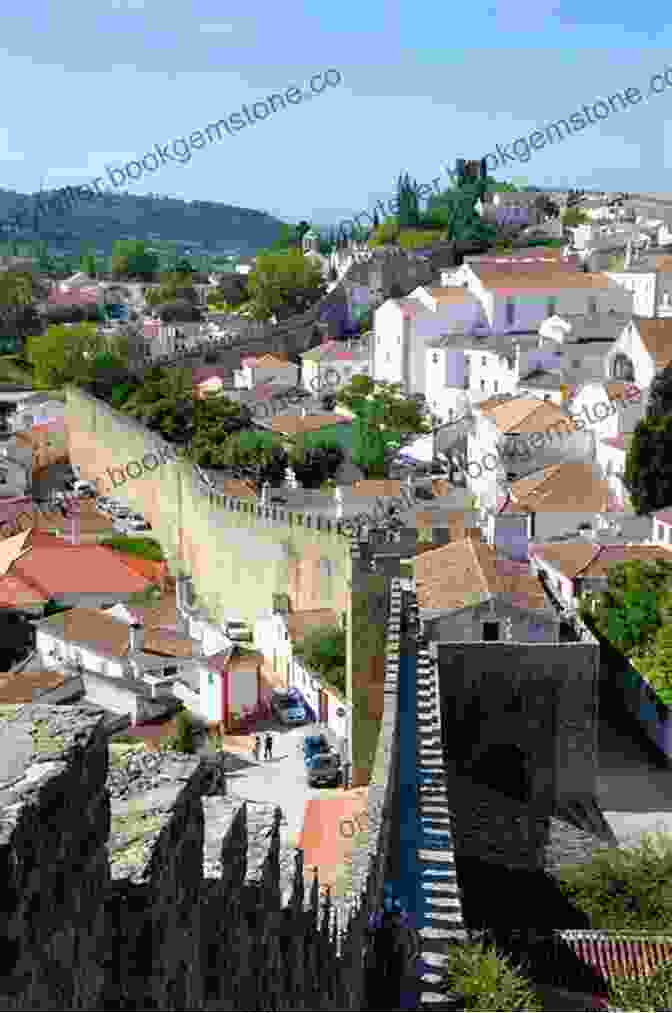 A Captivating View Of The Medieval Village Of Óbidos, Its Whitewashed Houses And Fortified Walls Nestled Amidst Rolling Hills Under A Clear Blue Sky. 22 Color Paintings Of Antonio De Carvalho Da Silva Porto Portuguese Naturalist Painter (November 11 1850 June 11 1893)